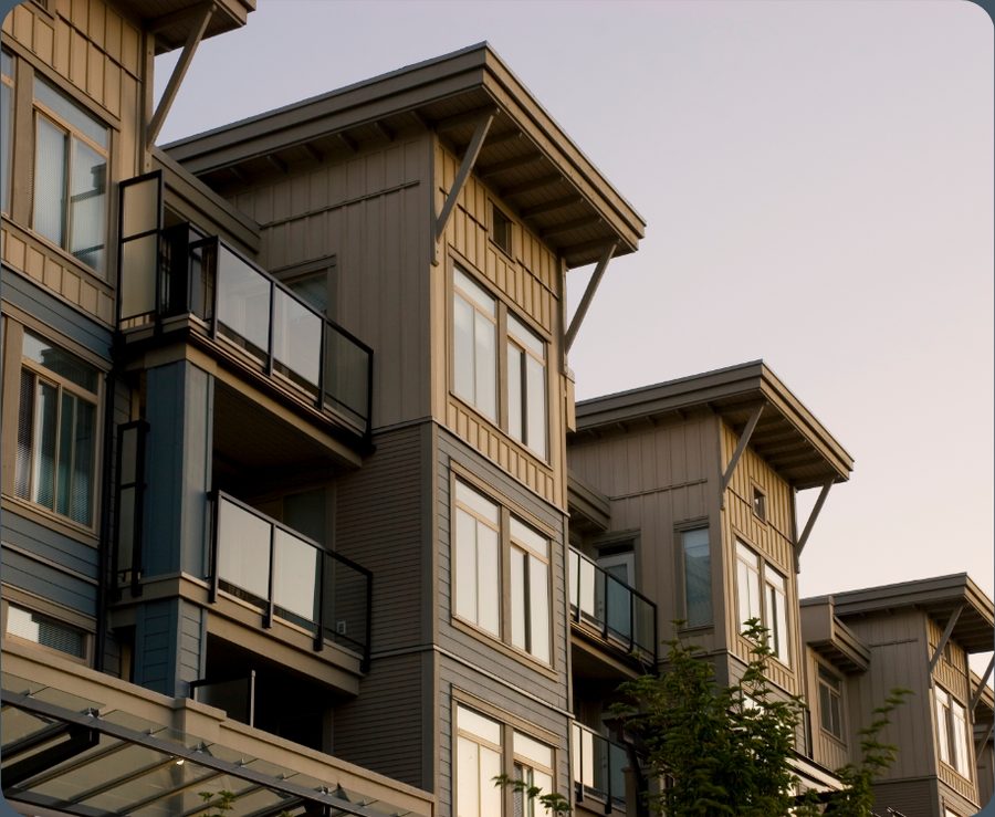 Timber and glass apartment building in a managed community at dusk